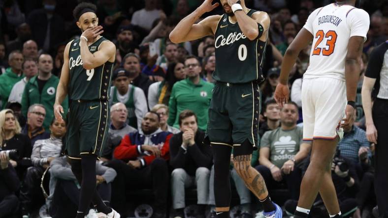 Mar 5, 2023; Boston, Massachusetts, USA; Boston Celtics forward Jayson Tatum (0) and guard Derrick White (9) react to a foul being called against the Celtics during the overtime period against the New York Knicks at TD Garden. Mandatory Credit: Winslow Townson-USA TODAY Sports