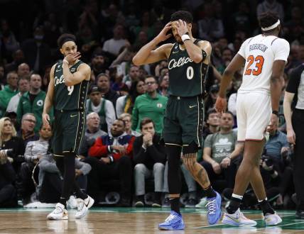 Mar 5, 2023; Boston, Massachusetts, USA; Boston Celtics forward Jayson Tatum (0) and guard Derrick White (9) react to a foul being called against the Celtics during the overtime period against the New York Knicks at TD Garden. Mandatory Credit: Winslow Townson-USA TODAY Sports