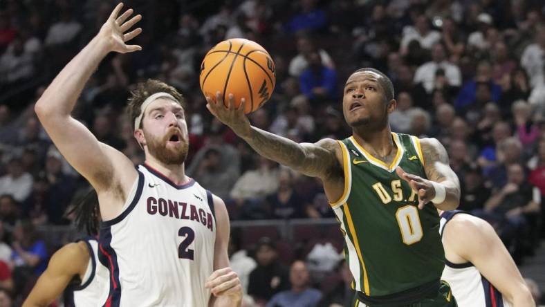 March 6, 2023; Las Vegas, NV, USA; San Francisco Dons guard Khalil Shabazz (0) shoots the basketball against Gonzaga Bulldogs forward Drew Timme (2) during the first half in the semifinals of the WCC Basketball Championships at Orleans Arena. Mandatory Credit: Kyle Terada-USA TODAY Sports