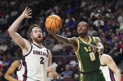 March 6, 2023; Las Vegas, NV, USA; San Francisco Dons guard Khalil Shabazz (0) shoots the basketball against Gonzaga Bulldogs forward Drew Timme (2) during the first half in the semifinals of the WCC Basketball Championships at Orleans Arena. Mandatory Credit: Kyle Terada-USA TODAY Sports