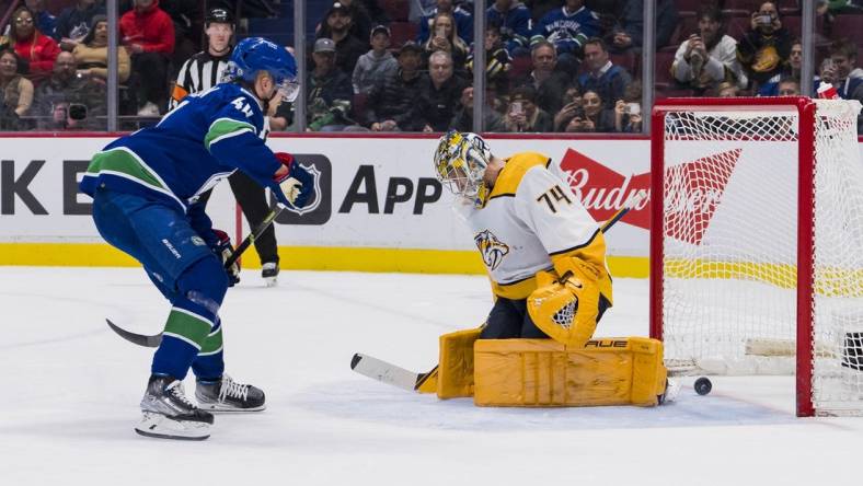 Mar 6, 2023; Vancouver, British Columbia, CAN; Vancouver Canucks forward Elias Pettersson (40) scores on Nashville Predators goalie Juuse Saros (74) during the shootout at Rogers Arena. Mandatory Credit: Bob Frid-USA TODAY Sports