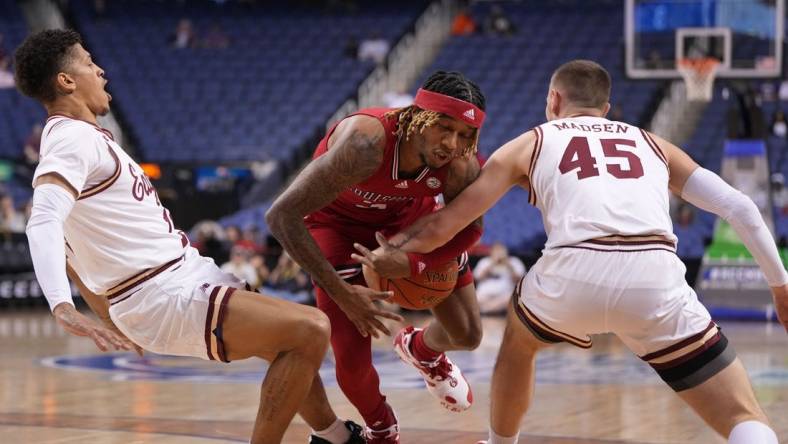 Mar 7, 2023; Greensboro, NC, USA; Louisville Cardinals guard El Ellis (3) with the ball as Boston College Eagles guard Makai Ashton-Langford (11) and guard Mason Madsen (45) defend in the first half of the first round of the ACC Tournament at Greensboro Coliseum. Mandatory Credit: Bob Donnan-USA TODAY Sports