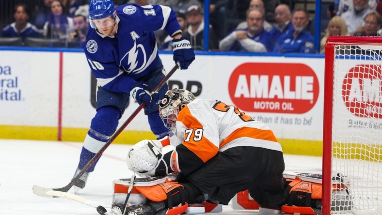 Mar 7, 2023; Tampa, Florida, USA;  Tampa Bay Lightning right wing Corey Perry (10) shoots the puck on Philadelphia Flyers goaltender Carter Hart (79) in the first period at Amalie Arena. Mandatory Credit: Nathan Ray Seebeck-USA TODAY Sports