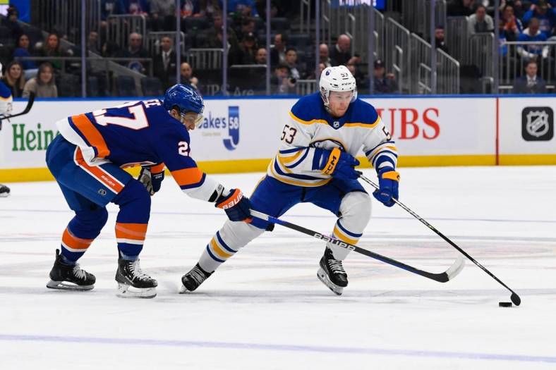 Mar 7, 2023; Elmont, New York, USA;  Buffalo Sabres left wing Jeff Skinner (53) skates with the puck defended by New York Islanders left wing Anders Lee (27) during the first period at UBS Arena. Mandatory Credit: Dennis Schneidler-USA TODAY Sports