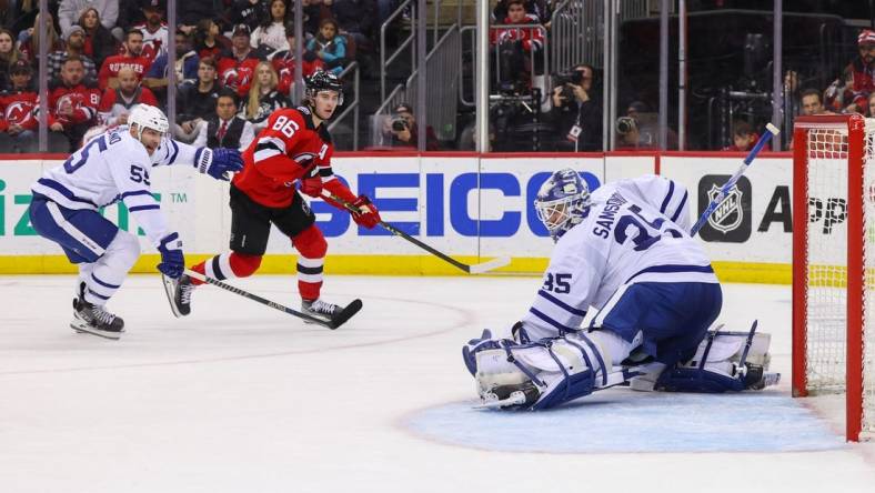 Mar 7, 2023; Newark, New Jersey, USA; Toronto Maple Leafs goaltender Ilya Samsonov (35) makes a save on New Jersey Devils center Jack Hughes (86) during the second period at Prudential Center. Mandatory Credit: Ed Mulholland-USA TODAY Sports