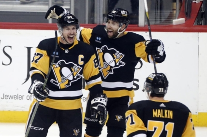 Mar 7, 2023; Pittsburgh, Pennsylvania, USA;  Pittsburgh Penguins center Sidney Crosby (87) reacts with left wing Jason Zucker (16) and center Evgeni Malkin (71) after scoring the game winning power play goal in overtime against the Columbus Blue Jackets at PPG Paints Arena. Pittsburgh won 5-4 in overtime. Mandatory Credit: Charles LeClaire-USA TODAY Sports