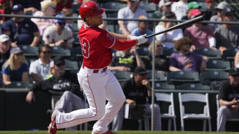 Mar 8, 2023; Tempe, Arizona, USA; Los Angeles Angels catcher Max Stassi (33) hits a single against the Colorado Rockies in the fourth inning at Tempe Diablo Stadium. Mandatory Credit: Rick Scuteri-USA TODAY Sports