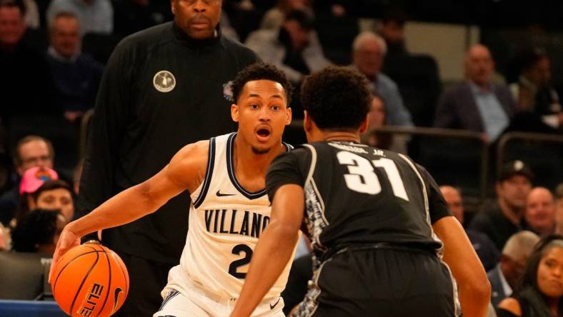 Mar 8, 2023; New York, NY, USA;  Villanova Wildcats guard Mark Armstrong (2) drives against Georgetown Hoyas guard Wayne Bristol Jr. (31) as Georgetown Hoyas head coach Patrick Ewing watches at rear at Madison Square Garden. Mandatory Credit: Robert Deutsch-USA TODAY Sports