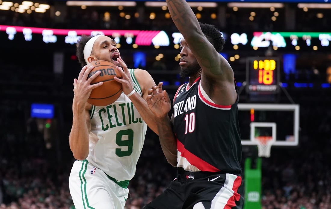 Mar 8, 2023; Boston, Massachusetts, USA; Boston Celtics guard Derrick White (9) drives the ball against Portland Trail Blazers forward Nassir Little (10) in the second half at TD Garden. Mandatory Credit: David Butler II-USA TODAY Sports