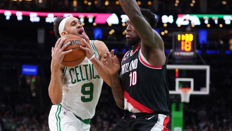 Mar 8, 2023; Boston, Massachusetts, USA; Boston Celtics guard Derrick White (9) drives the ball against Portland Trail Blazers forward Nassir Little (10) in the second half at TD Garden. Mandatory Credit: David Butler II-USA TODAY Sports