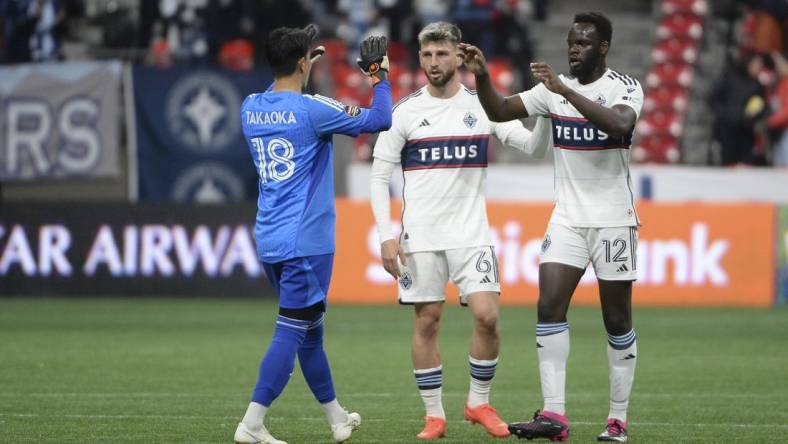 Mar 8, 2023; Vancouver, British Columbia, CAN;  Vancouver Whitecaps FC goalkeeper Yohei Takaoka (18) celebrates the win with defender Tristan Blackmon (6) and defender Karifa Yao (12) during the second half at BC Place Stadium. Mandatory Credit: Anne-Marie Sorvin-USA TODAY Sports