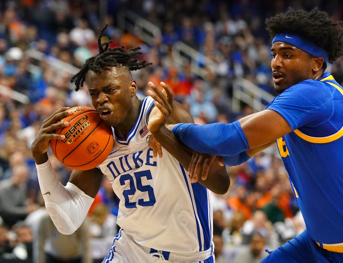 Mar 9, 2023; Greensboro, NC, USA; Duke Blue Devils forward Mark Mitchell (25) drives to the basket against Pittsburgh Panthers forward Blake Hinson (2) during the first half of the quarterfinals of the ACC tournament at Greensboro Coliseum. Mandatory Credit: John David Mercer-USA TODAY Sports