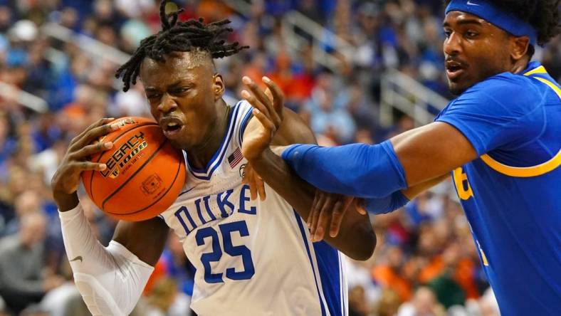 Mar 9, 2023; Greensboro, NC, USA; Duke Blue Devils forward Mark Mitchell (25) drives to the basket against Pittsburgh Panthers forward Blake Hinson (2) during the first half of the quarterfinals of the ACC tournament at Greensboro Coliseum. Mandatory Credit: John David Mercer-USA TODAY Sports