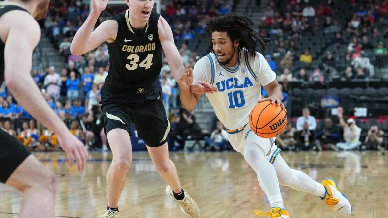 Mar 9, 2023; Las Vegas, NV, USA; UCLA Bruins guard Tyger Campbell (10) dribbles against Colorado Buffaloes center Lawson Lovering (34) during the first half at T-Mobile Arena. Mandatory Credit: Stephen R. Sylvanie-USA TODAY Sports