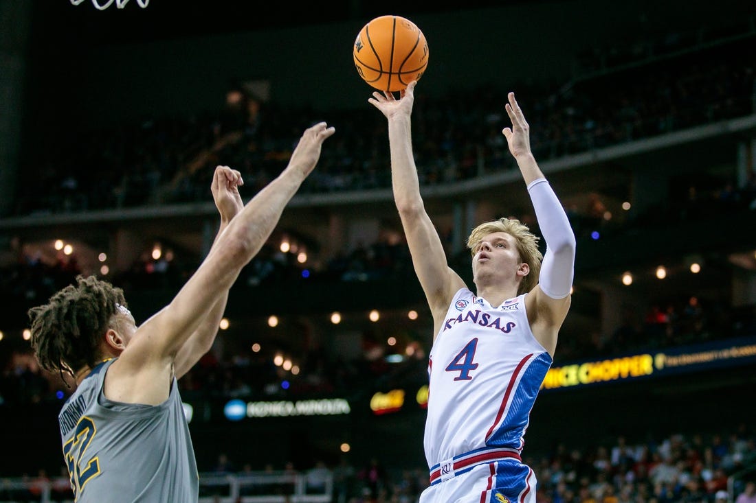 Mar 9, 2023; Kansas City, MO, USA; Kansas Jayhawks guard Gradey Dick (4) puts up a shot over West Virginia Mountaineers forward James Okonkwo (32) during the first half at T-Mobile Center. Mandatory Credit: William Purnell-USA TODAY Sports