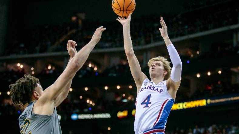 Mar 9, 2023; Kansas City, MO, USA; Kansas Jayhawks guard Gradey Dick (4) puts up a shot over West Virginia Mountaineers forward James Okonkwo (32) during the first half at T-Mobile Center. Mandatory Credit: William Purnell-USA TODAY Sports