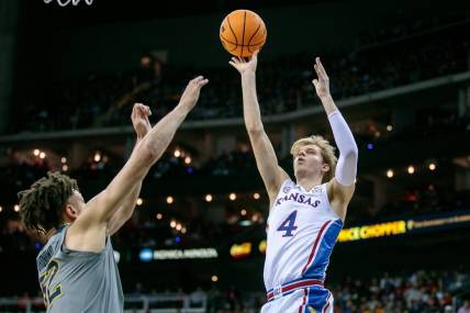 Mar 9, 2023; Kansas City, MO, USA; Kansas Jayhawks guard Gradey Dick (4) puts up a shot over West Virginia Mountaineers forward James Okonkwo (32) during the first half at T-Mobile Center. Mandatory Credit: William Purnell-USA TODAY Sports