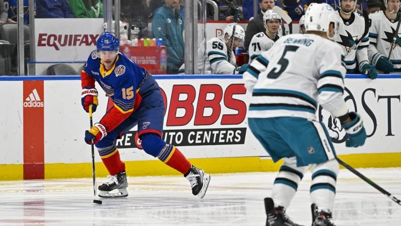 Mar 9, 2023; St. Louis, Missouri, USA;  St. Louis Blues left wing Jakub Vrana (15) controls the puck as San Jose Sharks defenseman Matt Benning (5) defends during the second period at Enterprise Center. Mandatory Credit: Jeff Curry-USA TODAY Sports