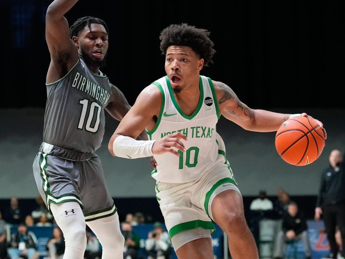 Mar 10, 2023; Frisco, TX, USA;  North Texas Mean Green guard Kai Huntsberry (10) drives to the basket past UAB Blazers guard Jordan Walker (10) during the second half at Ford Center at The Star. Mandatory Credit: Chris Jones-USA TODAY Sports
