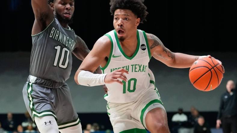 Mar 10, 2023; Frisco, TX, USA;  North Texas Mean Green guard Kai Huntsberry (10) drives to the basket past UAB Blazers guard Jordan Walker (10) during the second half at Ford Center at The Star. Mandatory Credit: Chris Jones-USA TODAY Sports