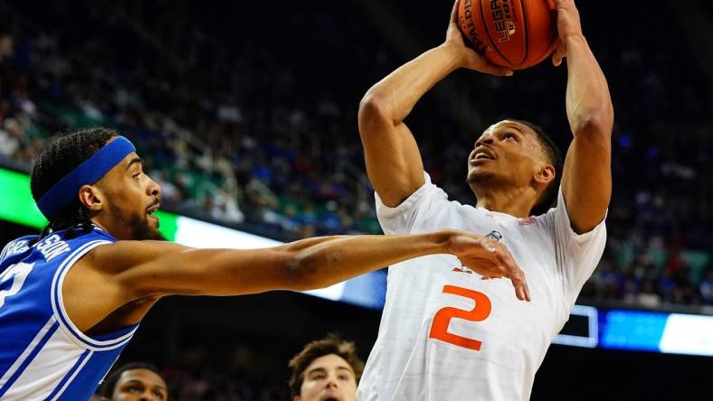 Mar 10, 2023; Greensboro, NC, USA; Miami (Fl) Hurricanes guard Isaiah Wong (2) goes to the basket against Duke Blue Devils guard Jacob Grandison (13) during the first half of the semifinals of the ACC tournament at Greensboro Coliseum. Mandatory Credit: John David Mercer-USA TODAY Sports