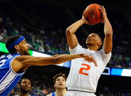 Mar 10, 2023; Greensboro, NC, USA; Miami (Fl) Hurricanes guard Isaiah Wong (2) goes to the basket against Duke Blue Devils guard Jacob Grandison (13) during the first half of the semifinals of the ACC tournament at Greensboro Coliseum. Mandatory Credit: John David Mercer-USA TODAY Sports