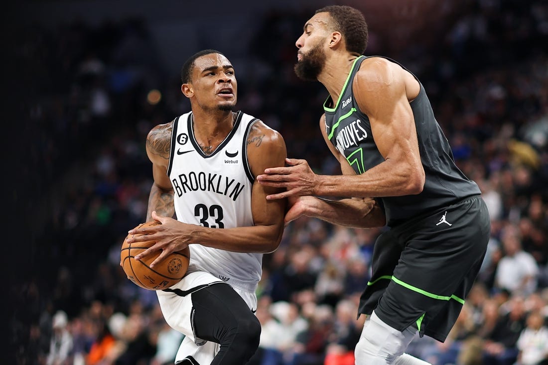 Mar 10, 2023; Minneapolis, Minnesota, USA; Brooklyn Nets center Nic Claxton (33) drives while Minnesota Timberwolves center Rudy Gobert (27) defends during the second quarter at Target Center. Mandatory Credit: Matt Krohn-USA TODAY Sports