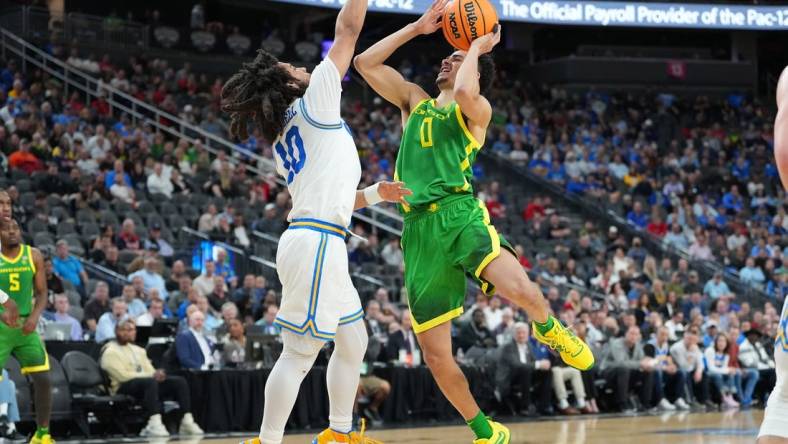 Mar 10, 2023; Las Vegas, NV, USA; Oregon Ducks guard Will Richardson (0) shoots against UCLA Bruins guard Tyger Campbell (10) during the first half at T-Mobile Arena. Mandatory Credit: Stephen R. Sylvanie-USA TODAY Sports