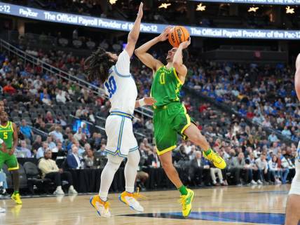 Mar 10, 2023; Las Vegas, NV, USA; Oregon Ducks guard Will Richardson (0) shoots against UCLA Bruins guard Tyger Campbell (10) during the first half at T-Mobile Arena. Mandatory Credit: Stephen R. Sylvanie-USA TODAY Sports