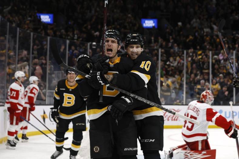 Mar 11, 2023; Boston, Massachusetts, USA; Boston Bruins left wing A.J. Greer (10) hugs right wing Garnet Hathaway (21) after he scored the go ahead goal against the Detroit Red Wings during the third period at TD Garden. Mandatory Credit: Winslow Townson-USA TODAY Sports