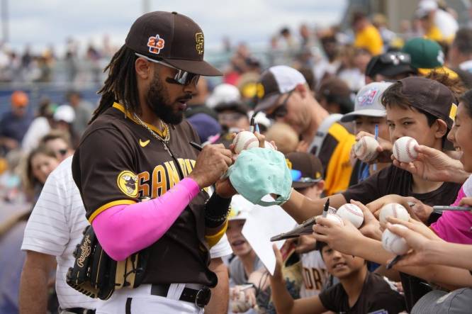 Mar 11, 2023; Peoria, Arizona, USA; San Diego Padres right fielder Fernando Tatis Jr. (23) signs autographs before a game against the Chicago White Sox at Peoria Sports Complex. Mandatory Credit: Rick Scuteri-USA TODAY Sports