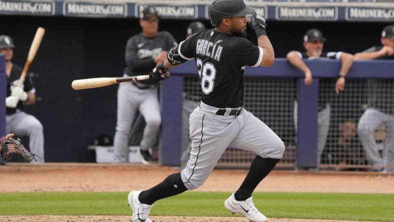 Mar 11, 2023; Peoria, Arizona, USA; Chicago White Sox second baseman Leury Garcia (28) hits against the San Diego Padres in the third inning at Peoria Sports Complex. Mandatory Credit: Rick Scuteri-USA TODAY Sports