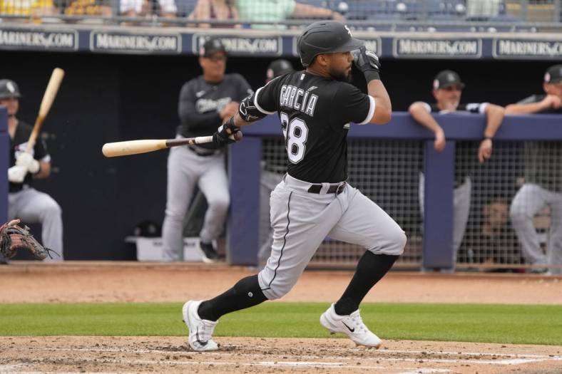 Mar 11, 2023; Peoria, Arizona, USA; Chicago White Sox second baseman Leury Garcia (28) hits against the San Diego Padres in the third inning at Peoria Sports Complex. Mandatory Credit: Rick Scuteri-USA TODAY Sports