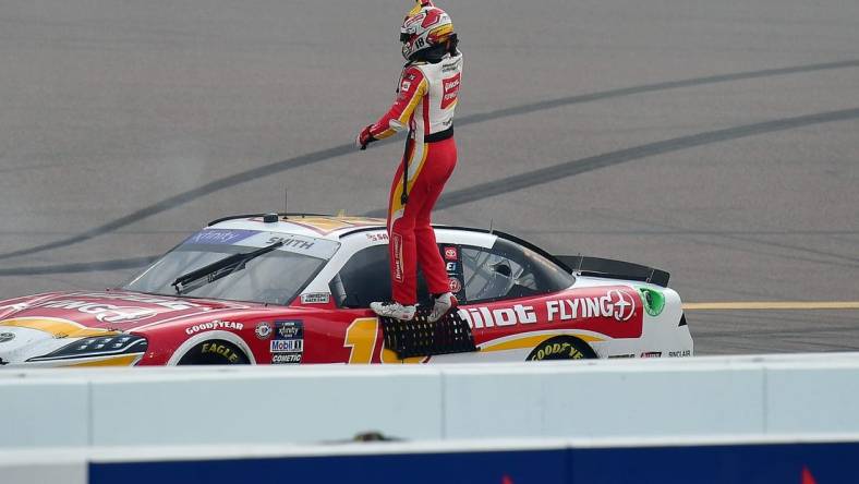 Mar 11, 2023; Avondale, Arizona, USA; NASCAR Xfinity Series driver Sammy Smith (18) celebrates his victory of  the United Rentals 200 at Phoenix Raceway. Mandatory Credit: Gary A. Vasquez-USA TODAY Sports