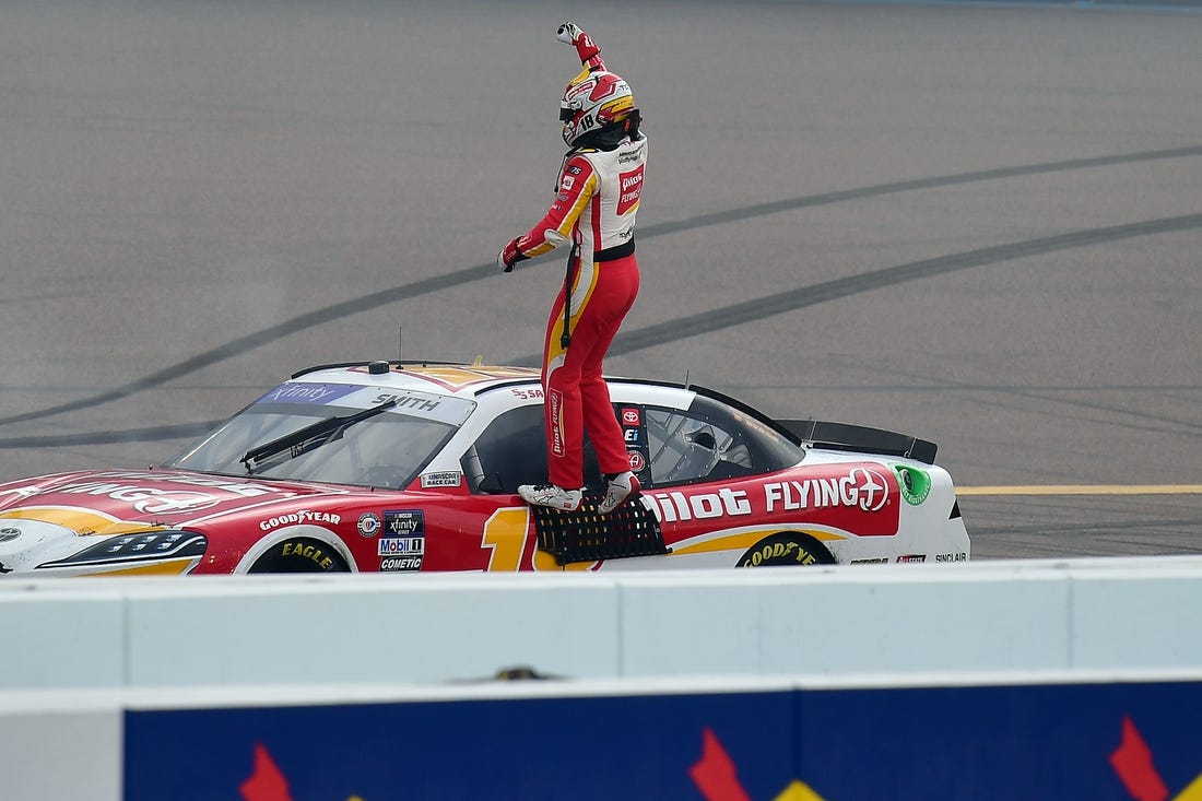 Mar 11, 2023; Avondale, Arizona, USA; NASCAR Xfinity Series driver Sammy Smith (18) celebrates his victory of  the United Rentals 200 at Phoenix Raceway. Mandatory Credit: Gary A. Vasquez-USA TODAY Sports