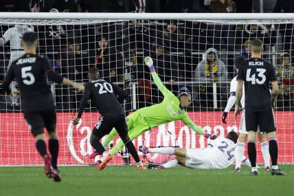 Mar 11, 2023; Washington, District of Columbia, USA; Orlando City SC goalkeeper Pedro Gallese (1) makes a save on D.C. United forward Christian Benteke (20) in the first half at Audi Field. Mandatory Credit: Geoff Burke-USA TODAY Sports