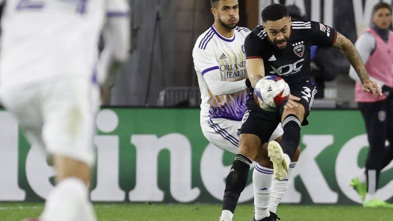 Mar 11, 2023; Washington, District of Columbia, USA; D.C. United defender Derrick Williams (3) clears the ball from Orlando City SC midfielder Mart n Ojeda (11) in the second half at Audi Field. Mandatory Credit: Geoff Burke-USA TODAY Sports