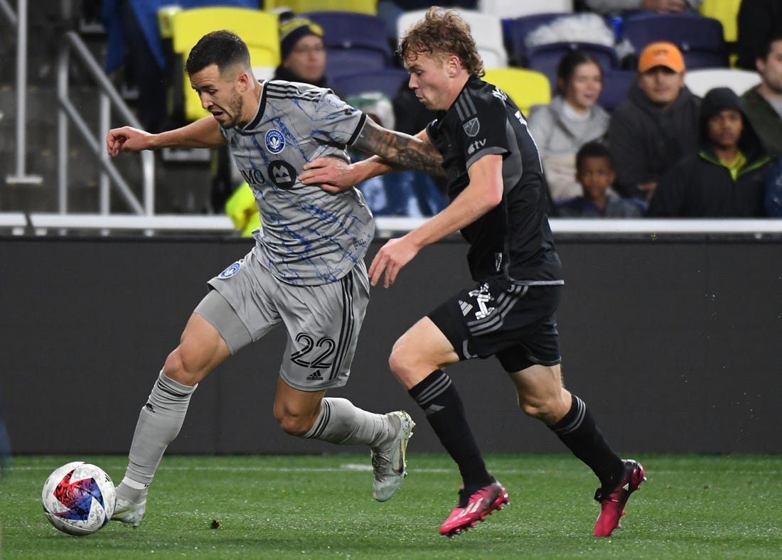 Mar 11, 2023; Nashville, Tennessee, USA; CF Montreal defender Aaron Herrera (22) and Nashville SC forward Jacob Shaffelburg (14) fights for the ball during the game at Geodis Park. Mandatory Credit: Christopher Hanewinckel-USA TODAY Sports