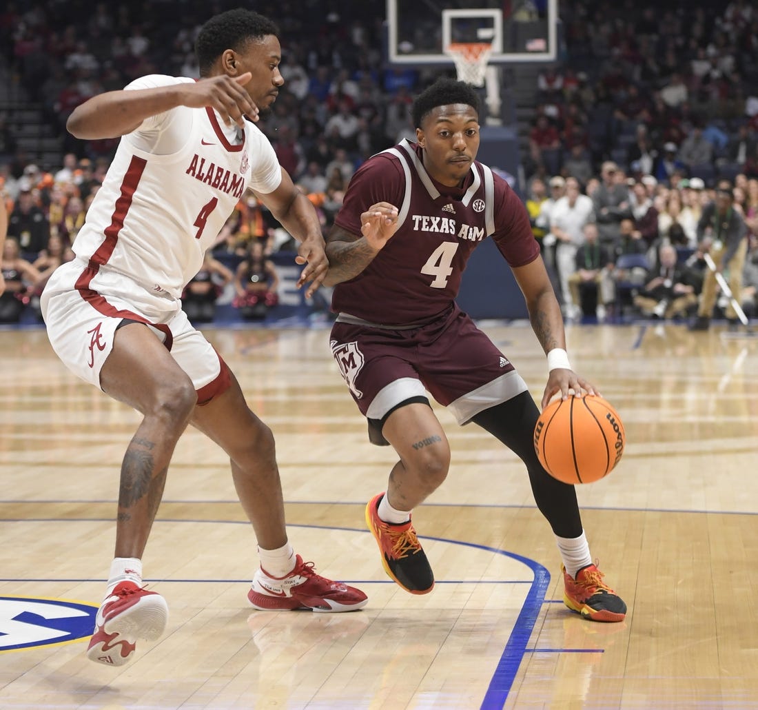 Mar 12, 2023; Nashville, TN, USA;  Texas A&M Aggies guard Wade Taylor IV (4) dribbles past Alabama Crimson Tide forward Noah Gurley (4) during the first half at Bridgestone Arena. Mandatory Credit: Steve Roberts-USA TODAY Sports