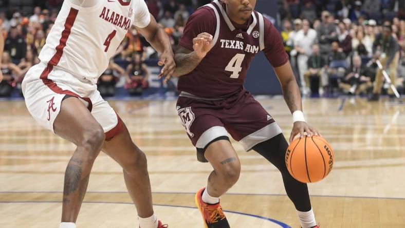 Mar 12, 2023; Nashville, TN, USA;  Texas A&M Aggies guard Wade Taylor IV (4) dribbles past Alabama Crimson Tide forward Noah Gurley (4) during the first half at Bridgestone Arena. Mandatory Credit: Steve Roberts-USA TODAY Sports