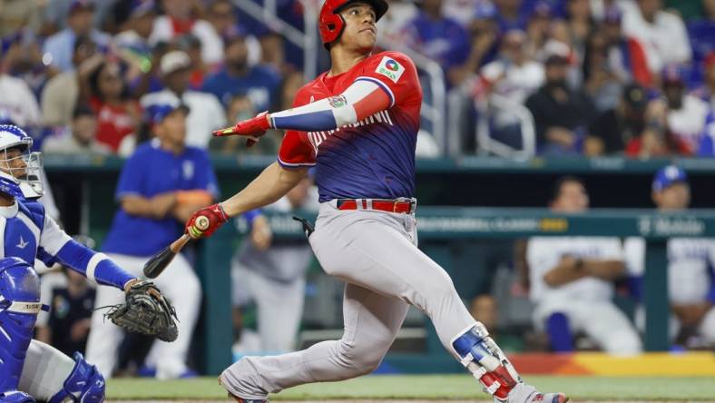 Mar 13, 2023; Miami, Florida, USA; Dominican Republic left fielder Juan Soto (22) hits a home run during the sixth inning against Nicaragua at LoanDepot Park. Mandatory Credit: Sam Navarro-USA TODAY Sports