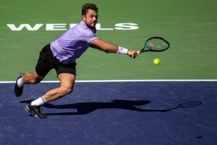 Stan Wawrinka of Switzerland runs up for a return to Holger Rune of Denmark during third-round their match at the BNP Paribas Open at the Indian Wells Tennis Garden in Indian Wells, Calif., Monday, March 13, 2023.