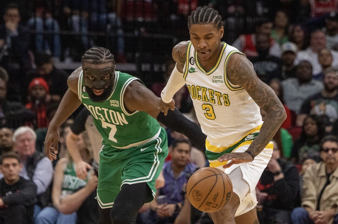 Mar 13, 2023; Houston, Texas, USA; Houston Rockets guard Kevin Porter Jr. (3) dribbles against Boston Celtics guard Jaylen Brown (7) in the second quarter at Toyota Center. Mandatory Credit: Thomas Shea-USA TODAY Sports