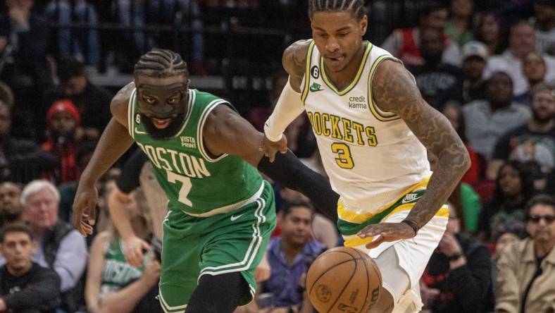 Mar 13, 2023; Houston, Texas, USA; Houston Rockets guard Kevin Porter Jr. (3) dribbles against Boston Celtics guard Jaylen Brown (7) in the second quarter at Toyota Center. Mandatory Credit: Thomas Shea-USA TODAY Sports