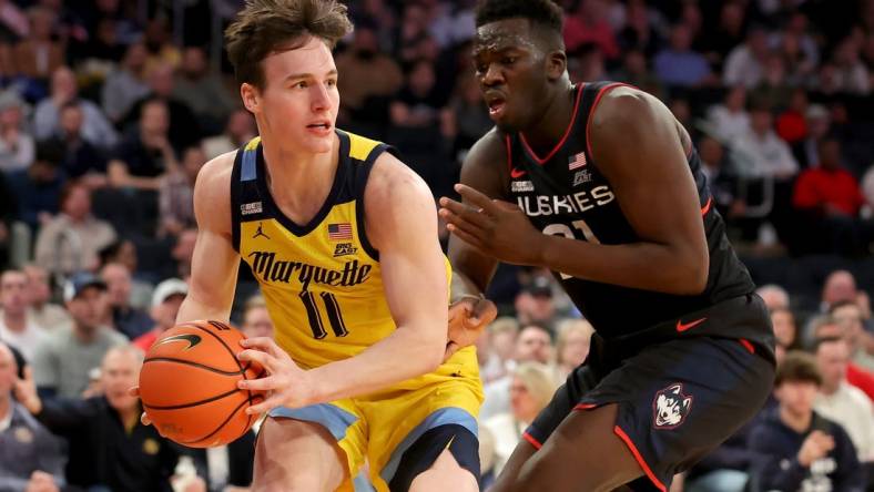 Mar 10, 2023; New York, NY, USA; Marquette Golden Eagles guard Tyler Kolek (11) controls the ball against Connecticut Huskies forward Adama Sanogo (21) during the second half at Madison Square Garden. Mandatory Credit: Brad Penner-USA TODAY Sports