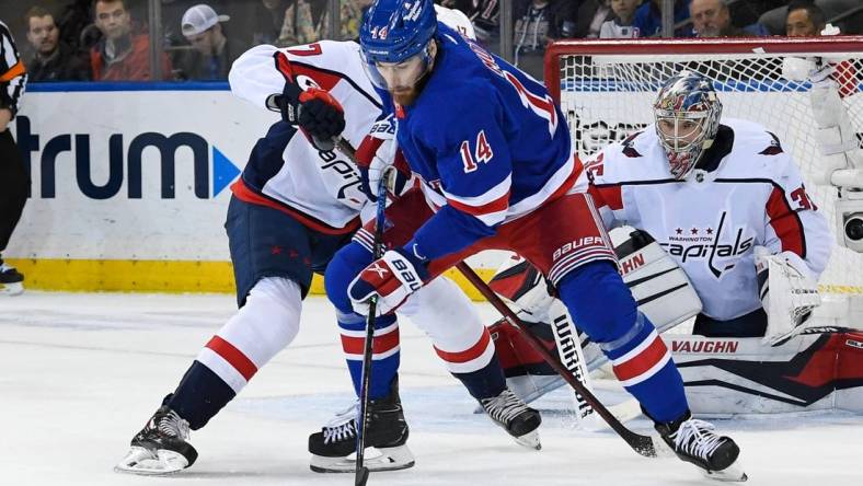 Mar 14, 2023; New York, New York, USA;  New York Rangers center Tyler Motte (14) plays the puck defended by Washington Capitals center Dylan Strome (17) during the first period at Madison Square Garden. Mandatory Credit: Dennis Schneidler-USA TODAY Sports