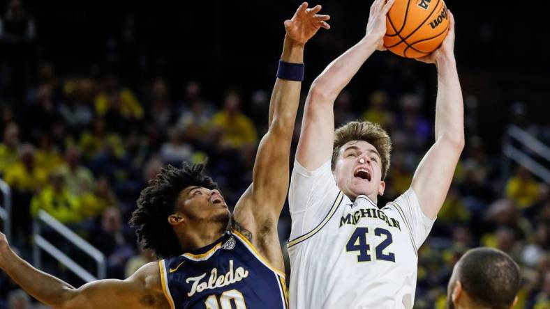 Michigan forward Will Tschetter (42) grabs a rebound against Toledo guard RayJ Dennis (10) during the first half of the first round of the NIT at Crisler Center in Ann Arbor on Tuesday, March 14, 2023.