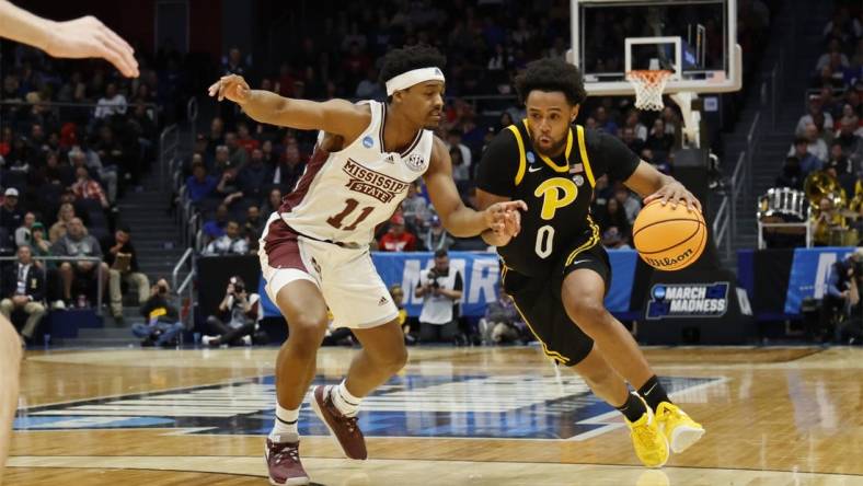 Mar 14, 2023; Dayton, OH, USA; Pittsburgh Panthers guard Nelly Cummings (0) moves the ball defended by Mississippi State Bulldogs guard Eric Reed Jr. (11) in the first half at UD Arena. Mandatory Credit: Rick Osentoski-USA TODAY Sports