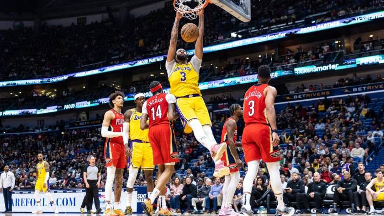 Mar 14, 2023; New Orleans, Louisiana, USA; Los Angeles Lakers forward Anthony Davis (3) dunks the ball against New Orleans Pelicans forward Brandon Ingram (14) during the second half at Smoothie King Center. Mandatory Credit: Stephen Lew-USA TODAY Sports