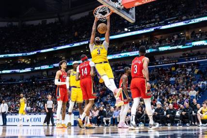 Mar 14, 2023; New Orleans, Louisiana, USA; Los Angeles Lakers forward Anthony Davis (3) dunks the ball against New Orleans Pelicans forward Brandon Ingram (14) during the second half at Smoothie King Center. Mandatory Credit: Stephen Lew-USA TODAY Sports
